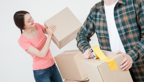 Professional movers handling furniture and boxes in a Finchley home removal