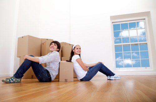 Trained movers using PPE while handling household items