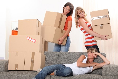 Professional movers transporting household furniture across Finchley